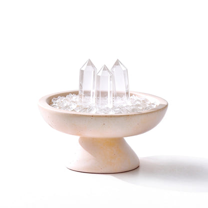 White crystal grid vessel with three crystal points on a travertine stone base