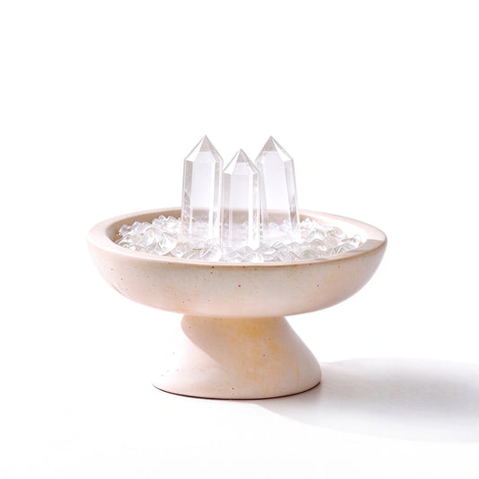 White crystal grid vessel with three crystal points on a travertine stone base