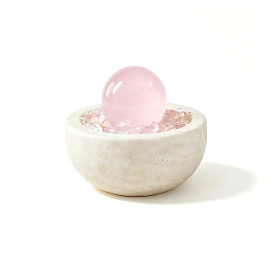 Rose Radiance Treasure Basin crystal vessel in a natural stone basin with crystal points