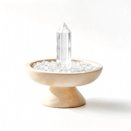 Clear crystal focus plinth vessel with natural crystal pieces on a travertine base