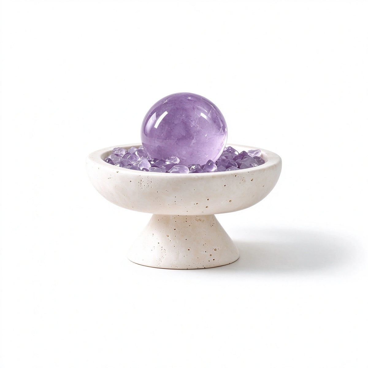 Amethyst crystal sphere arranged in a travertine vessel with natural crystal pieces