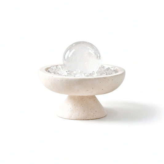 Clear crystal radiance plinth vessel with natural crystal pieces on a travertine base
