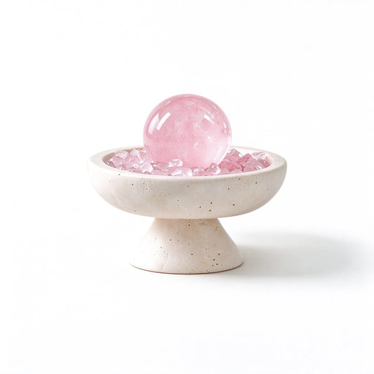 Rose Quartz crystal sphere arranged in a travertine vessel with natural crystal pieces