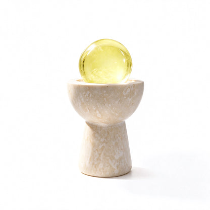 Citrine crystal sphere chalice arranged in a travertine vessel with natural crystal pieces