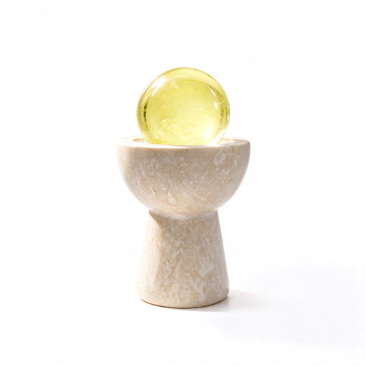 Citrine crystal sphere chalice arranged in a travertine vessel with natural crystal pieces