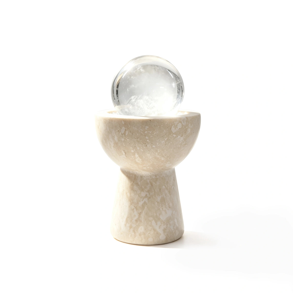 White crystal sphere chalice arranged in a travertine vessel with natural crystal pieces
