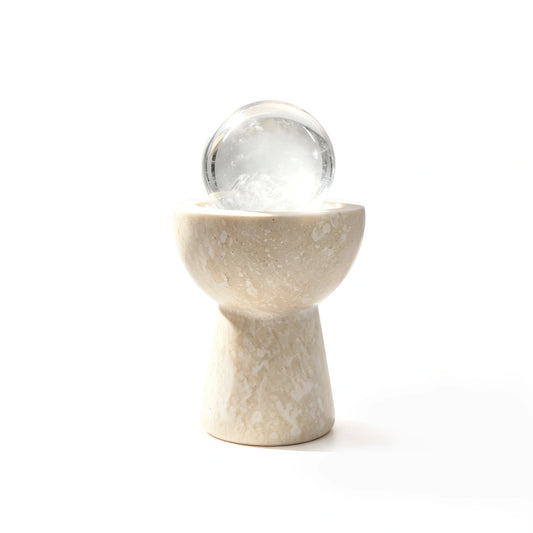 White crystal sphere chalice arranged in a travertine vessel with natural crystal pieces