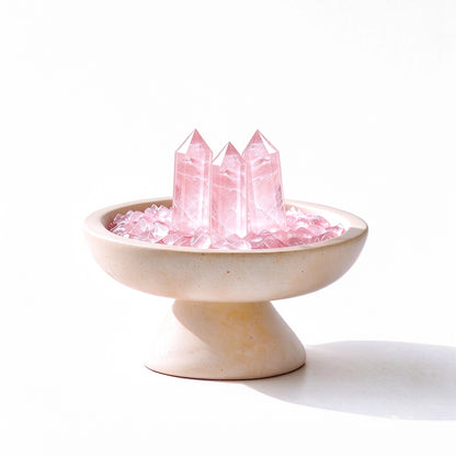 Rose Quartz crystal array plinth vessel with natural crystal pieces on a travertine base
