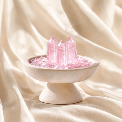 Close-up of the rose quartz crystal array vessel with natural stones and travertine details