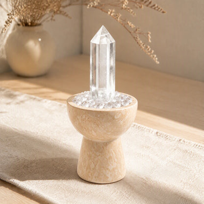 Overhead view of white crystals and loose crystal stones arranged in the vessel