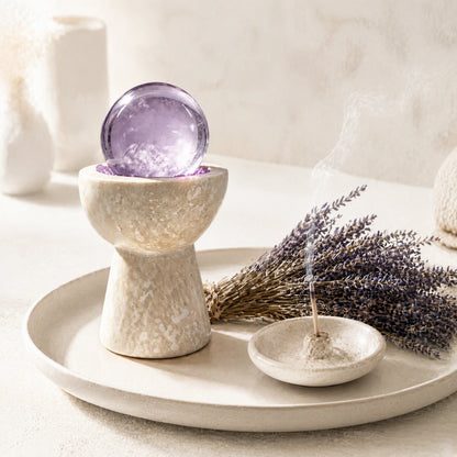 Overhead view of amethyst crystals and loose crystal stones arranged in the vessel