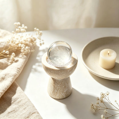 Overhead view of white crystals and loose crystal stones arranged in the vessel